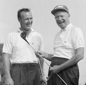 Sept. 9, 1960. President Dwight Eisenhower, right, enjoys a laugh with Arnold Palmer before they played a round of golf together in a foursome at the Gettysburg Country Club. (AP Photo/Paul Vathis, File)